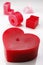 Love spelt in red and pink candles with a heart shape candle. Decorative background design