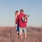 Love story. Beautiful young couple walking in meadow, outdoor