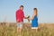 Love story. Beautiful young couple walking in meadow, outdoor