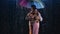 Love story of couple in rain, expressed in passionate dance. Romantic meeting of two lovers. Couple under bright colored