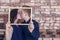 Love story. Gentle kiss of young lovers, loving couple, Photo frame on a brick wall background