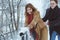 Love story in the winter park. Young cheerful couple outdoor. Happy couple plaing with fresh snow. Valentine`s Day and