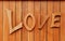 Love text on wooden background