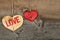 Love Valentines message two wooden hearts sign on rough grey background