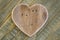 Love Valentines wooden heart on light green painted background