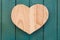 Love Valentines wooden heart on turquoise painted background