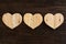 Love Valentines wooden hearts on rough driftwood background