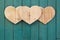 Love Valentines wooden hearts on turquoise painted background