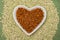 Love vegan and vegetarian food concept, plant based minced meat in heart shaped plate on soya beans background