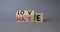 Love vs Hate symbol. Wooden cubes with words Hate and Love. Beautiful grey background. Valentines Day and Love vs Hate concept.