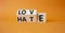 Love vs Hate symbol. Wooden cubes with words Hate and Love. Beautiful orange background. Valentines Day and Love vs Hate concept.