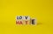 Love vs Hate symbol. Wooden cubes with words Hate and Love. Beautiful yellow background. Valentines Day and Love vs Hate concept.