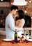 Love, wine and romance, couple hug on valentines day date at home with rose petals and bokeh. Date night, man and woman
