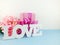 Love word copy with gift and flower close up background