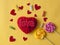 Love word, heart and lollipop candies on yellow paper  background. Top view