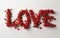 Love word made of red roses. Love, relationship, valentine visual concept