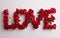 Love word made of red roses. Love, relationship, valentine visual concept