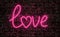 Love word neon text on grunge wall background