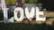 Love word outdoors. Big white plastic letters wedding decoration