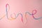 Love word written with woolen thread lettering, concept and background for Valentine`s Day, copy space.