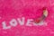 Love wording arrange by bead with thread bead in condom