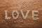 `Love` writing made out of little wooden hearts