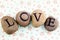 Love written with painted pebbles