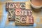 Love yourself word abstract in wood type