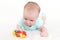 Lovely 2 months baby girl plays with rattle
