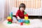 Lovely 2 years toddler plays plastic blocks