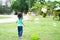 Lovely active little asian girl playing with soap bubble outdoor in the park