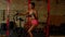 Lovely active sporty fitness african american female riding exercise bike at gym
