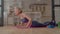 Lovely active sporty fitness mature woman standing in yoga plank position