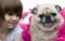 A lovely adorable young child with pug