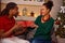 Lovely afro American couple exchanging presents on Christmas