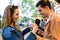 Lovely attractive couple sharing and eating hamburger together in eat market in the street.