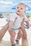 Lovely baby boy outdoor on beach in summer