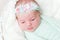 Lovely baby girl with blue flowery headband, closeup