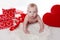 Lovely baby with Valentine\'s heart and gifts boxes