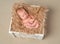 Lovely bare newborn in wooden box with fluffy blanket