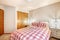 Lovely bedroom interior with red checked bed