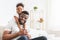 Lovely black daughter hugging young dad, home interior