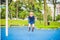 Lovely blond little boy on a swing in the park. Adorable boy having fun at the playground