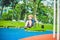 Lovely blond little boy on a swing in the park. Adorable boy having fun at the playground