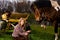 Lovely blond woman sitting by horse