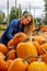 A Lovely Blonde European Model Enjoys Shopping For Pumpkins And Flowers For Halloween Holiday