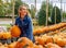 A Lovely Blonde European Model Enjoys Shopping For Pumpkins And Flowers For Halloween Holiday