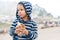 Lovely boy holds tasty hotdog walking in mountain park