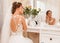 Lovely bride, model preparing to wedding day in front of mirror