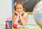 Lovely caucasian preschooler girl bored at lesson. Education concept